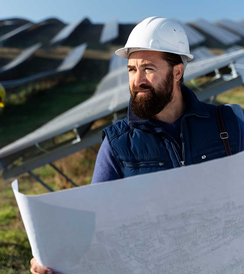 Two solar engineers reviewing installation plans on a tablet